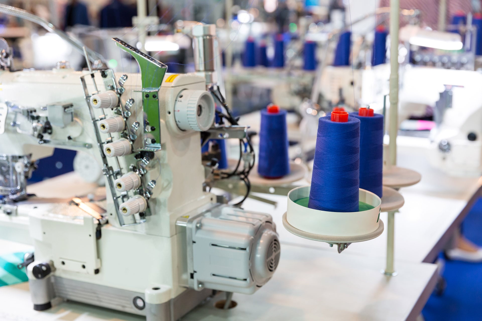 sewing-machine-and-cloth-nobody-clothing-factory-2021-08-26-16-25-53-utc-min